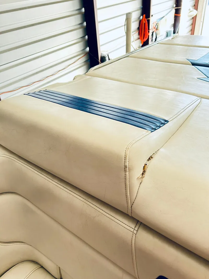 Slide: The Image of 2005 Fountain 42 Executioner boat interior with beige upholstery and blue accents. - 33