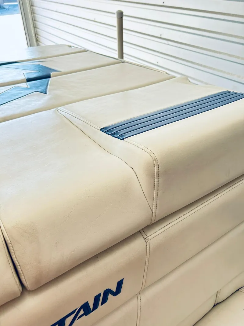 Slide: The Image of 2005 Fountain 42 Executioner boat interior with beige upholstery and blue accents. - 34