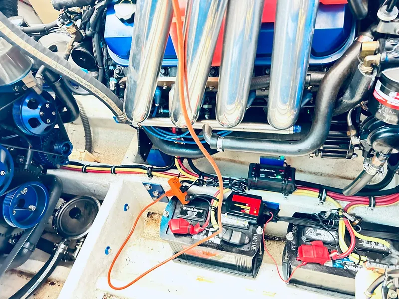 Slide: The Image of Engine compartment of a 2005 Fountain 42 Executioner boat, showcasing batteries and wiring. - 41
