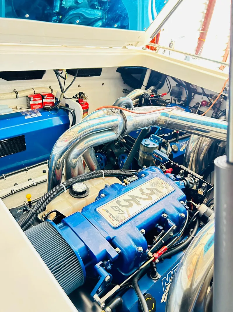 Slide: The Image of Engine compartment of a 2005 Fountain 42 Executioner boat, showcasing powerful machinery. - 44