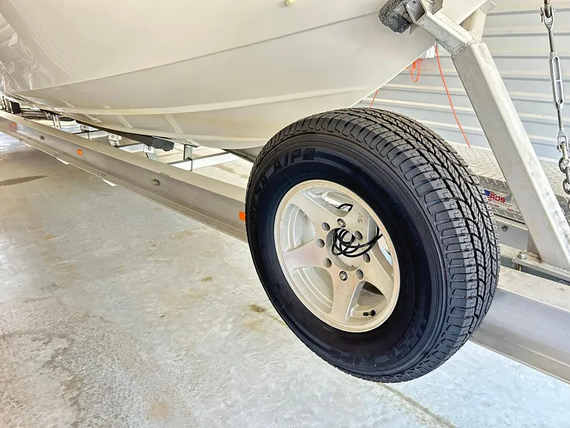 Slide: The Image of Trailer wheel supporting a 2005 Fountain 42 Executioner boat in storage. - 48