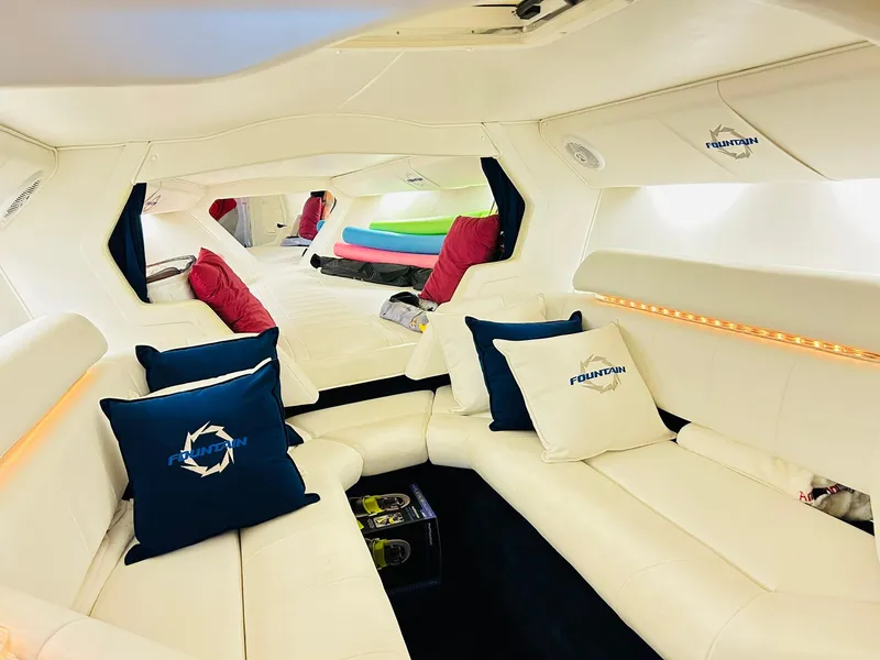 Slide: The Image of Luxurious interior of a 2005 Fountain 42 Executioner boat with white seating and colorful cushions. - 6