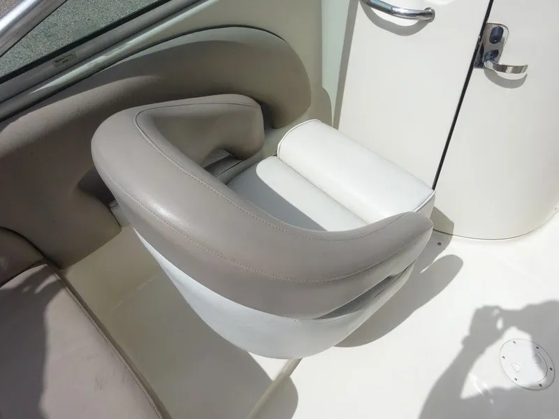 Slide: The Image of 2004 Sea Ray 220 Sundeck boat seat with beige and white upholstery. - 11