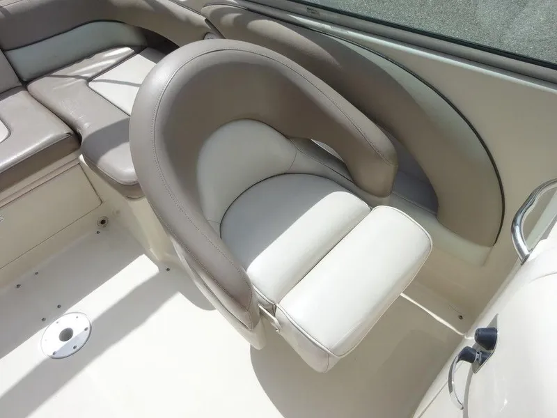 Slide: The Image of 2004 Sea Ray 220 Sundeck interior seating, featuring plush, curved design in beige and white. - 12