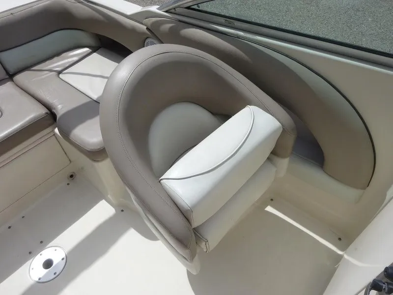 Slide: The Image of 2004 Sea Ray 220 Sundeck interior seating with beige and white upholstery. - 13