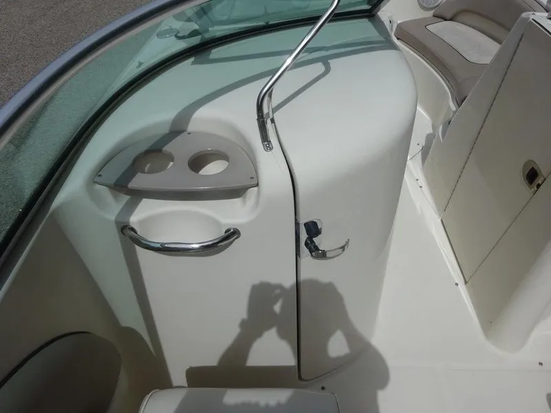 Slide: The Image of 2004 Sea Ray 220 Sundeck interior with cup holders and seating area. - 16