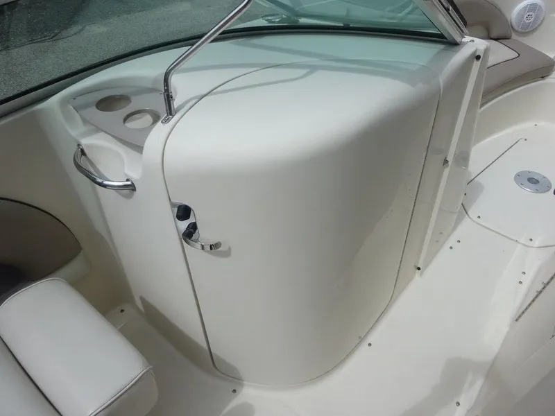 Slide: The Image of 2004 Sea Ray 220 Sundeck interior with white seating and cup holders. - 17