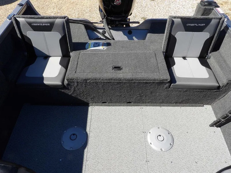Slide: The Image of 2025 Crestliner 1750 Fish Hawk SC boat interior with carpeted deck and storage compartments. - 13