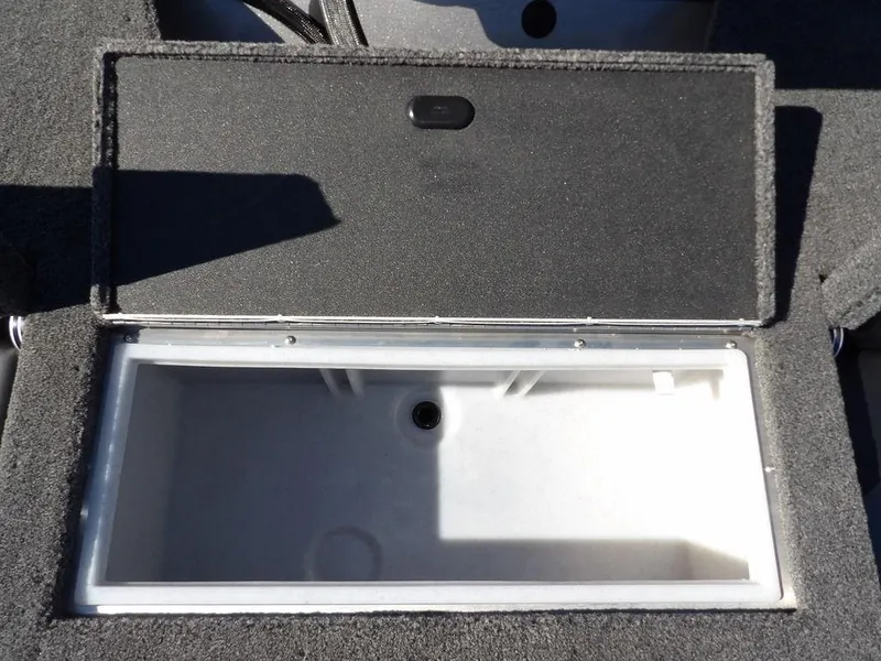 Slide: The Image of 2025 Crestliner 1750 Fish Hawk SC battery compartment with wiring and storage. - 15