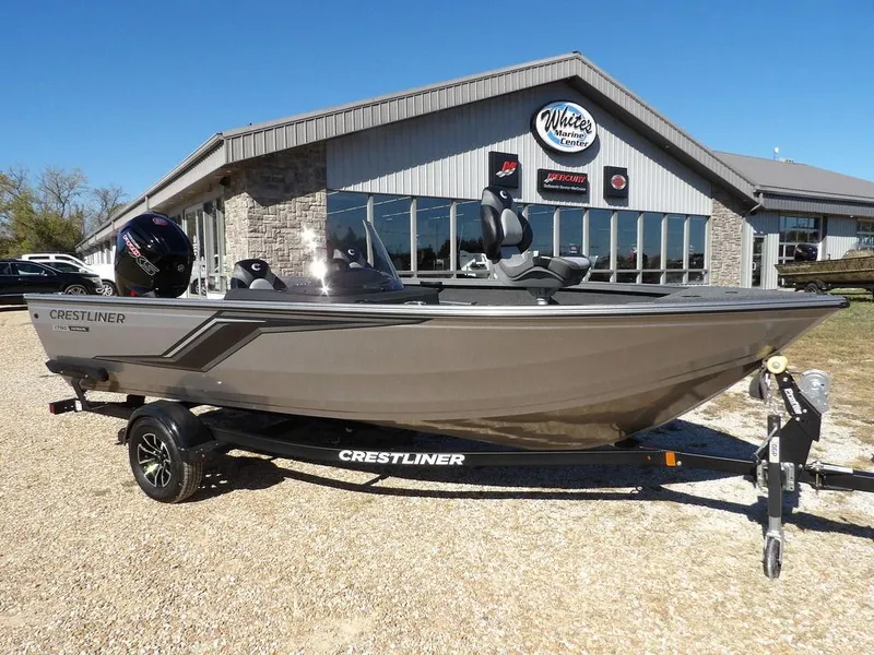 Slide: The Image of 2025 Crestliner 1750 Fish Hawk SC boat in vibrant red, displayed outside a marine center. - 2