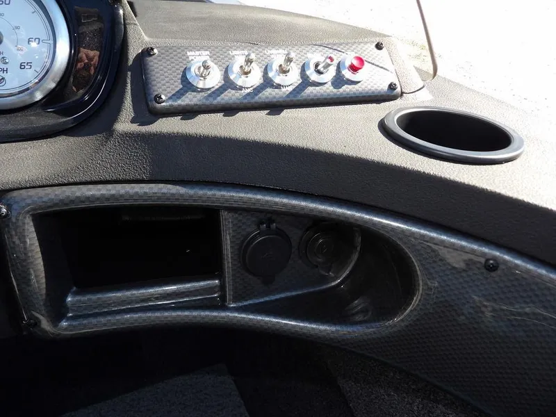 Slide: The Image of Control panel of 2025 Crestliner 1750 Fish Hawk SC with switches and cup holder. - 24