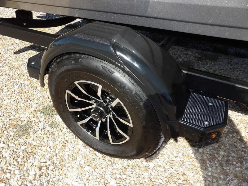 Slide: The Image of 2025 Crestliner 1750 Fish Hawk SC trailer wheel on gravel surface. - 42