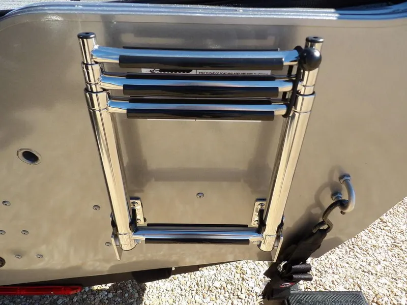 Slide: The Image of 2025 Crestliner 1750 Fish Hawk SC with a foldable ladder on a red hull. - 44