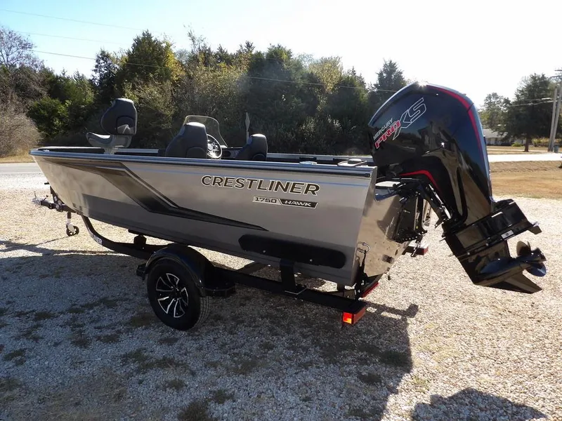 Slide: The Image of 2025 Crestliner 1750 Fish Hawk SC boat in vibrant red on a trailer. - 6