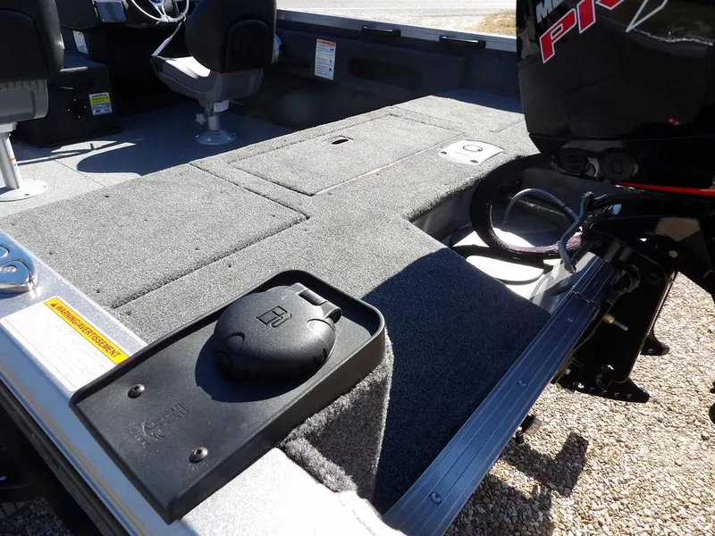 Slide: The Image of 2025 Crestliner 1750 Fish Hawk SC boat, red exterior, on a trailer with outboard motor. - 9