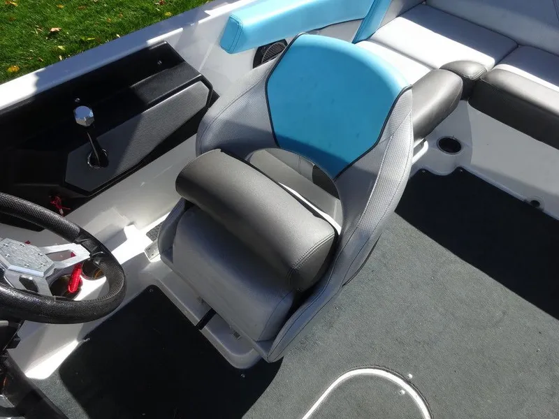 Slide: The Image of 2019 MasterCraft NXT20 boat interior with blue and gray seating and steering wheel. - 10