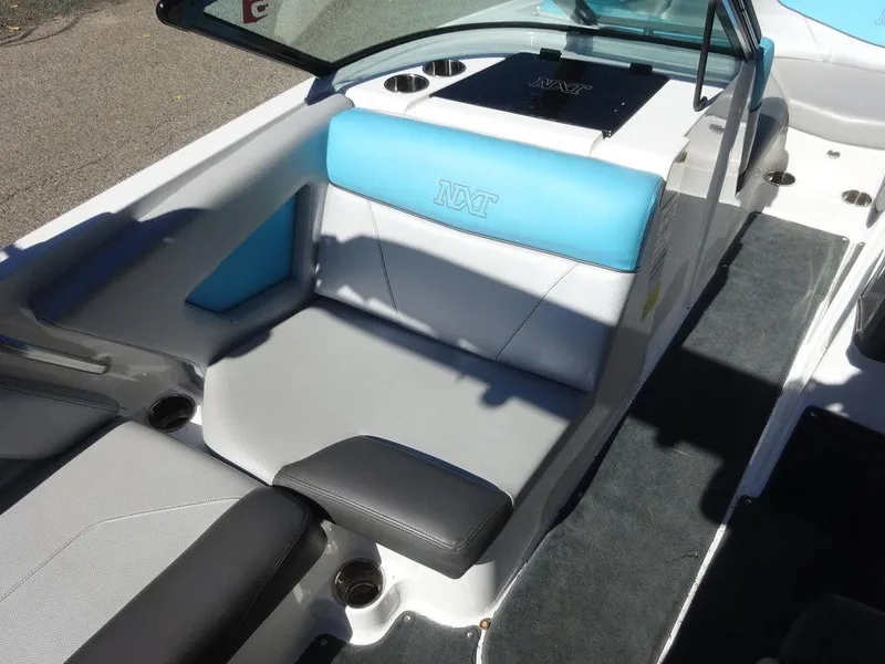 Slide: The Image of 2019 MasterCraft NXT20 boat interior with blue and gray seating. - 11