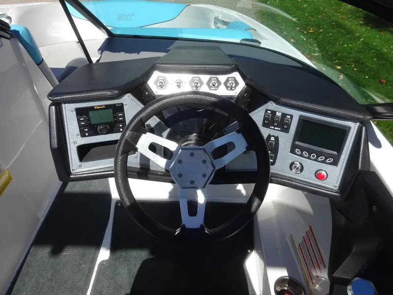 Slide: The Image of 2019 MasterCraft NXT20 dashboard with steering wheel and control panels. - 13