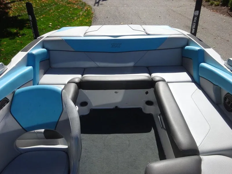 Slide: The Image of 2019 MasterCraft NXT20 boat interior with blue and gray seating, spacious and comfortable design. - 17