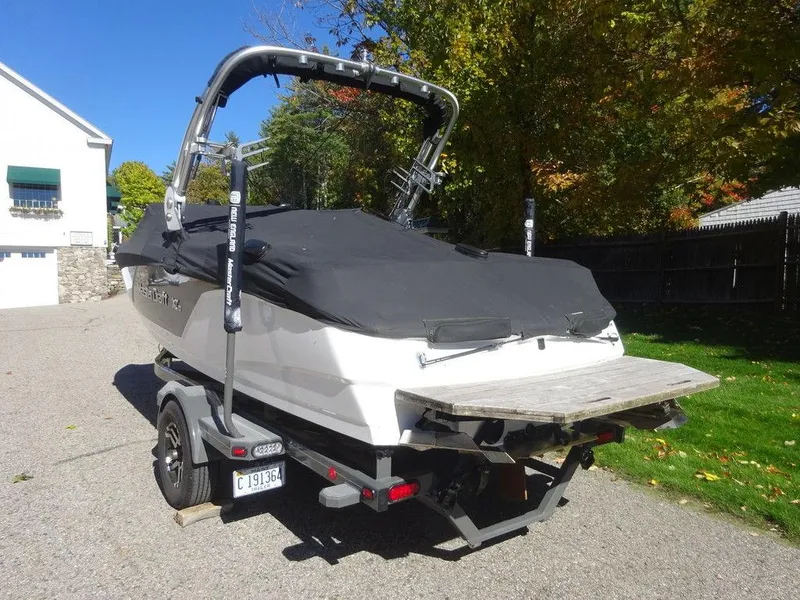 Slide: The Image of 2019 MasterCraft NXT20 boat on trailer, covered, parked outdoors. - 2
