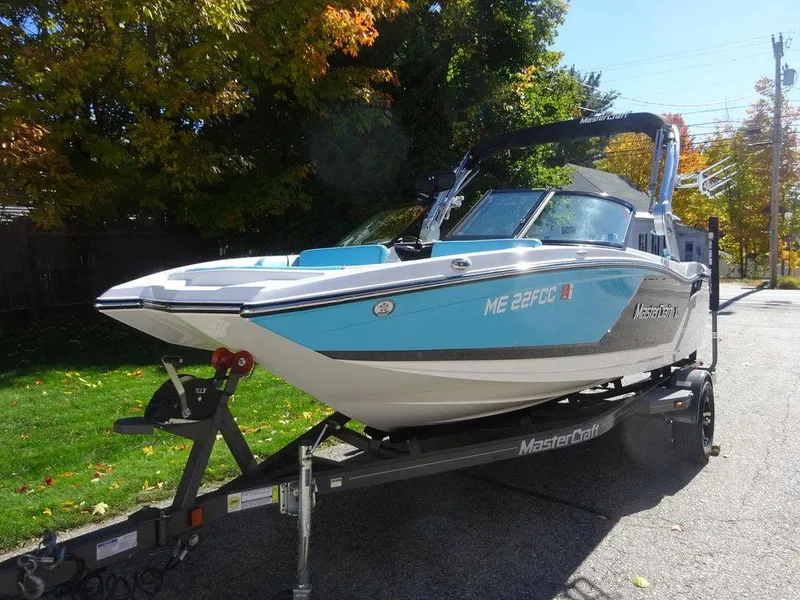 Slide: The Image of 2019 MasterCraft NXT20 boat on trailer, parked on a sunny street with autumn trees. - 5
