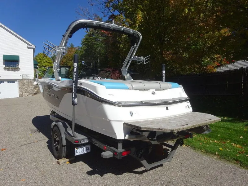 Slide: The Image of 2019 MasterCraft NXT20 boat on trailer, parked outdoors in a residential area. - 6