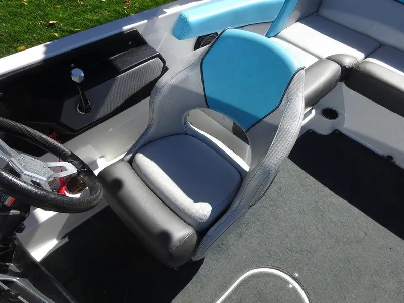 Slide: The Image of 2019 MasterCraft NXT20 boat interior with blue and gray seating and steering wheel. - 9