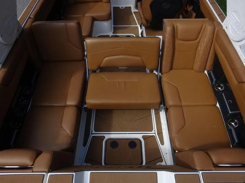 Slide: The Image of 2020 Malibu M240 boat interior with luxurious brown leather seating and modern design. - 8