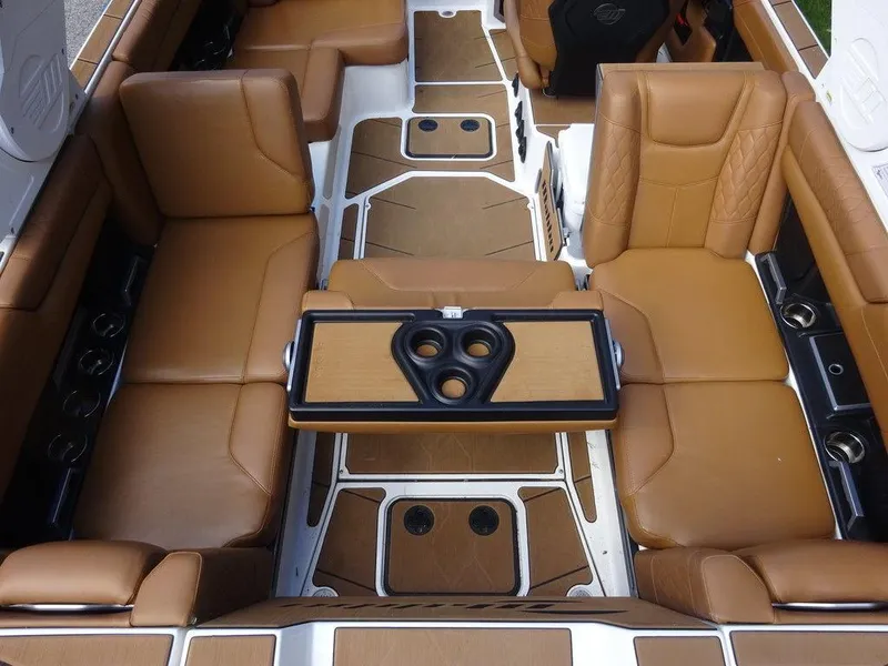 Slide: The Image of Luxurious interior of 2020 Malibu M240 boat with tan leather seating and central table. - 9