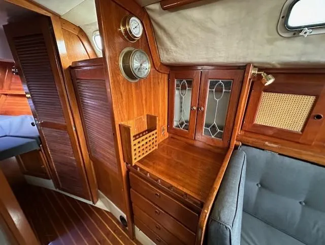 Slide: The Image of Interior of 1979 CAL 39 MK II Tall Rig sailboat with wooden cabinetry and gray cushioned seating. - 17