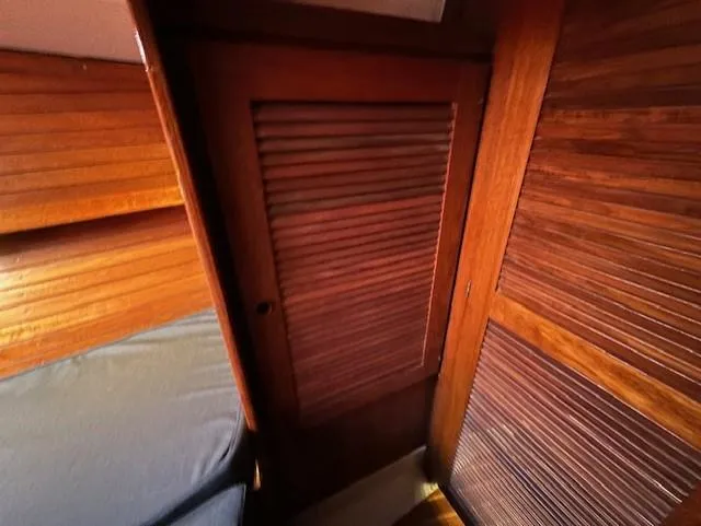 Slide: The Image of Interior of 1979 CAL 39 MK II Tall Rig sailboat with wooden furnishings and gray seating. - 18