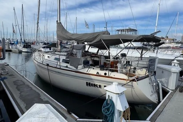 Slide: The Image of 1979 CAL 39 MK II Tall Rig sailboat docked in marina, side view. - 2