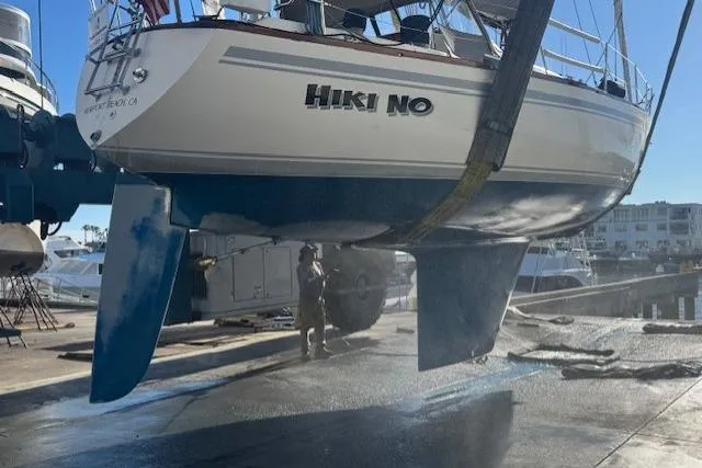 Slide: The Image of 1979 CAL 39 MK II Tall Rig sailboat being cleaned at a marina. - 57