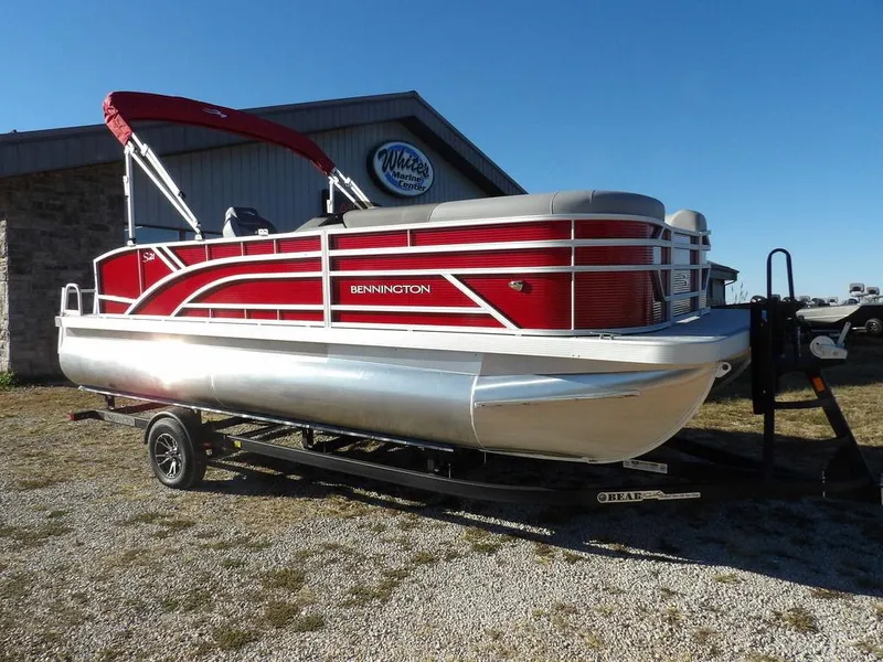 The Image of 2025 Bennington 21 SLJ pontoon boat with red accents on a trailer. - 0