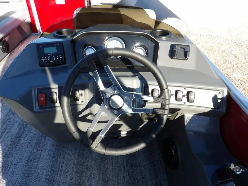 Slide: The Image of 2025 Bennington 21 SLJ boat dashboard with steering wheel and control panel. - 17