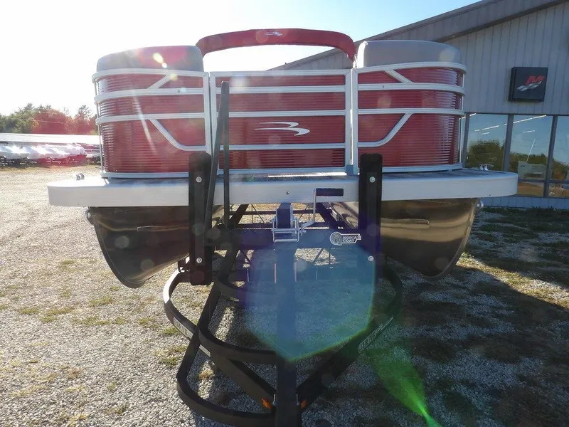 Slide: The Image of 2025 Bennington 21 SLJ pontoon boat on trailer, rear view in outdoor setting. - 2