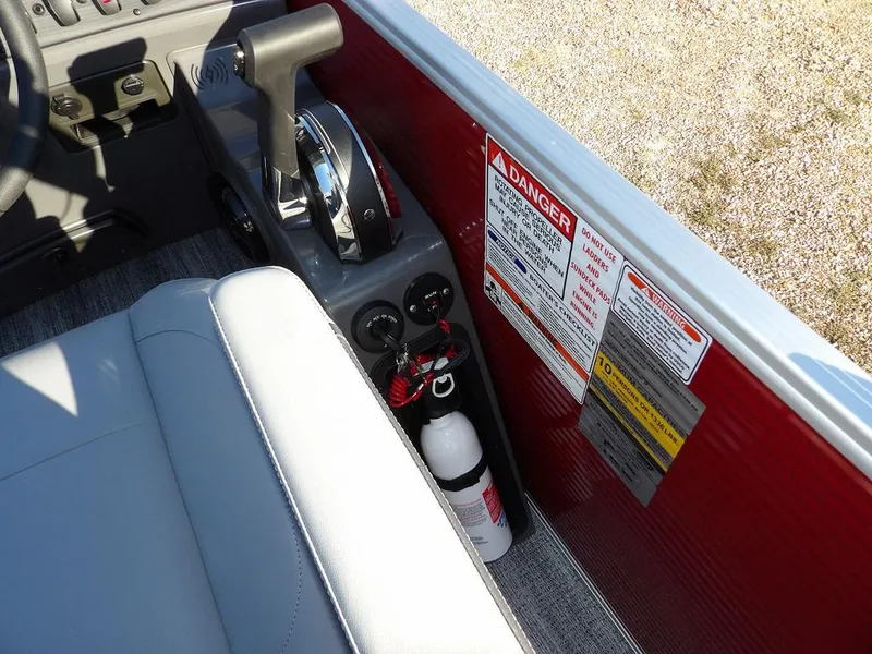 Slide: The Image of 2025 Bennington 21 SLJ boat interior with control panel and safety labels. - 27