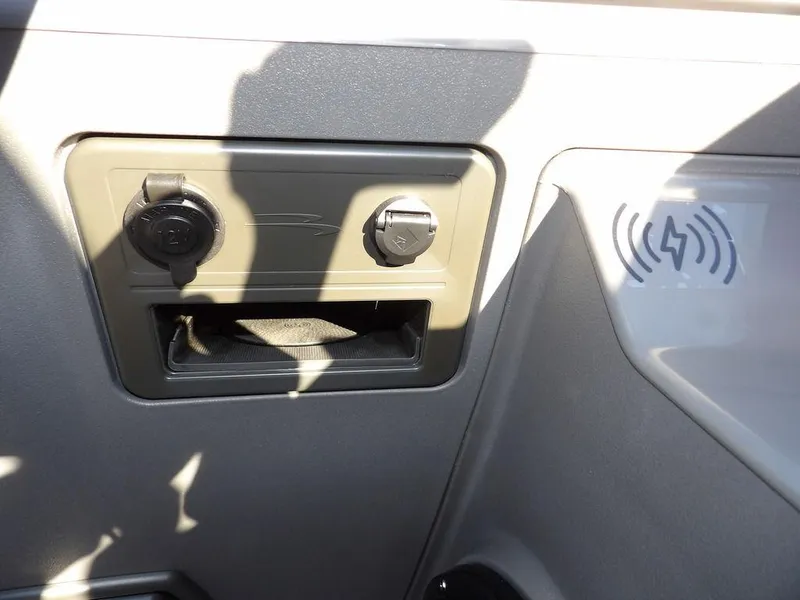 Slide: The Image of 2025 Bennington 21 SLJ dashboard with charging ports and wireless charging pad. - 28