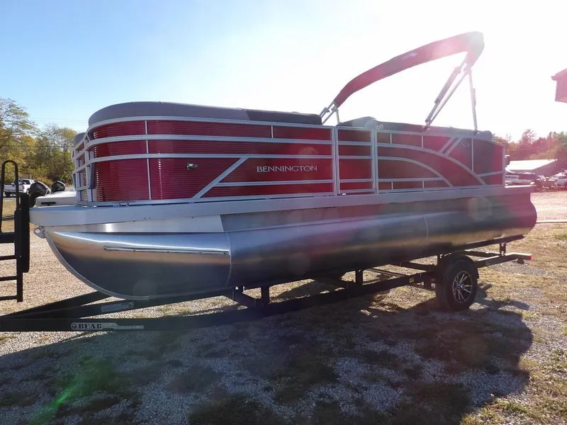 Slide: The Image of 2025 Bennington 21 SLJ pontoon boat with red exterior on a trailer. - 3