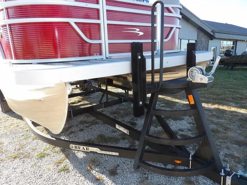 Slide: The Image of 2025 Bennington 21 SLJ pontoon boat on trailer, red exterior, parked outdoors. - 37