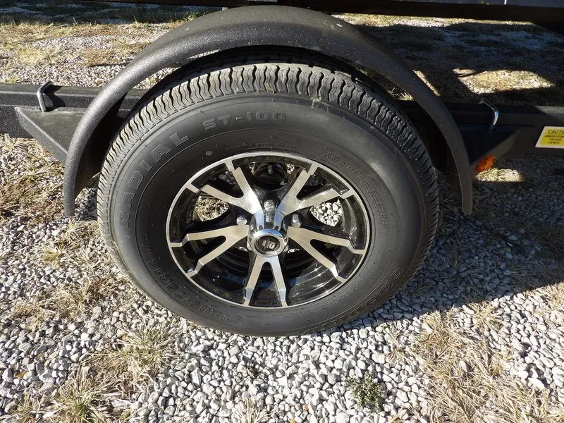 Slide: The Image of 2025 Bennington 21 SLJ trailer wheel on gravel surface. - 41