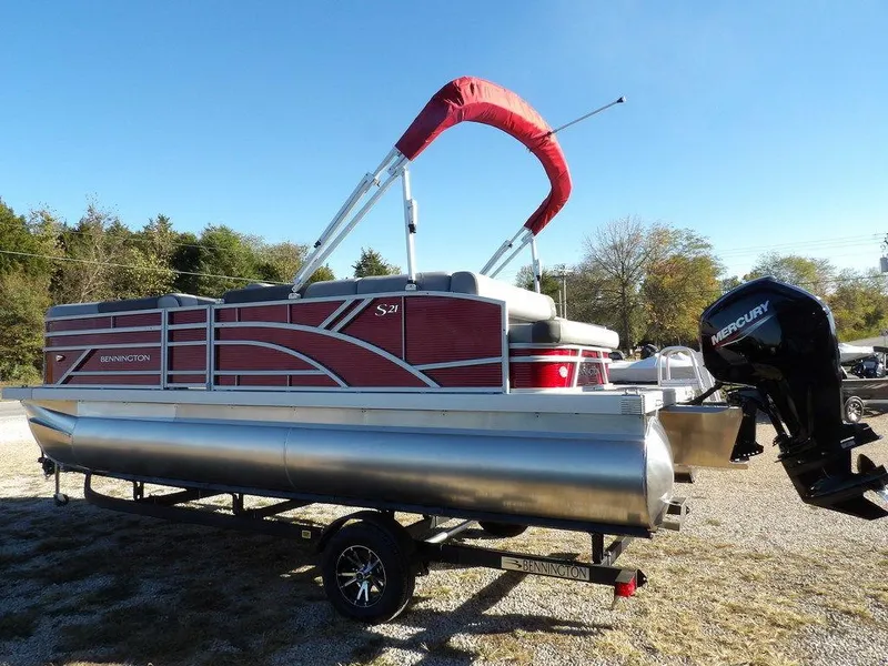 Slide: The Image of 2025 Bennington 21 SLJ pontoon boat with red canopy and Mercury outboard motor. - 5