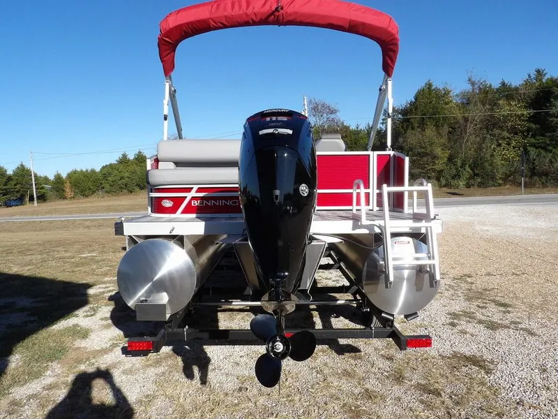 Slide: The Image of 2025 Bennington 21 SLJ pontoon boat with red canopy and outboard motor. - 7