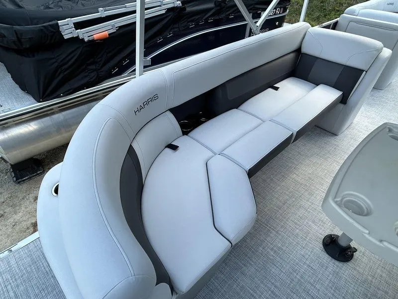 Slide: The Image of 2022 Harris Cruiser 230 boat interior with gray cushioned seating. - 5
