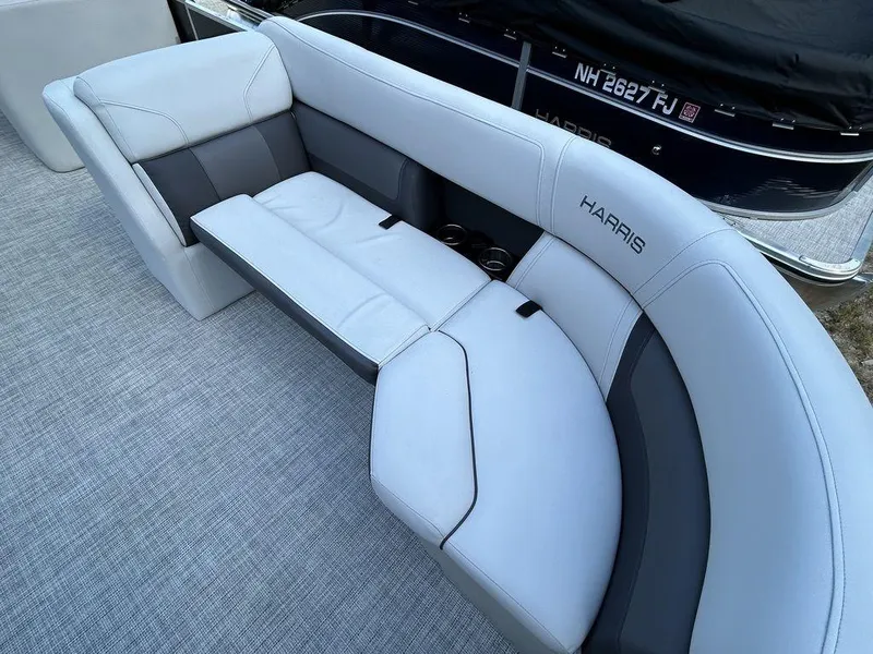 Slide: The Image of 2022 Harris Cruiser 230 boat interior with gray seating and cup holders. - 8
