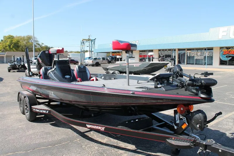 Slide: The Image of 2025 Phoenix 721 ZXL bass boat on trailer in parking lot, featuring sleek design and modern equipment. - 2
