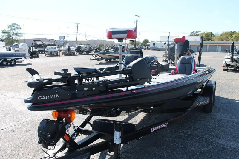 Slide: The Image of 2025 Phoenix 721 ZXL bass boat with Garmin equipment, parked on a trailer in a lot. - 3