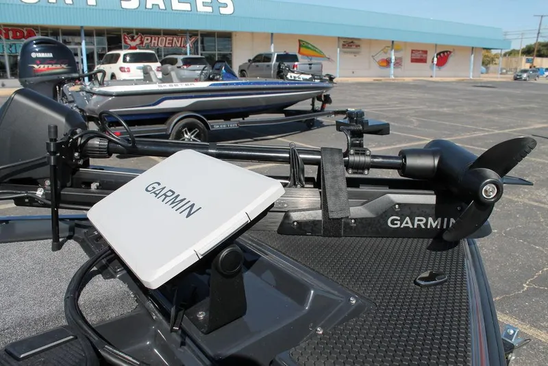 Slide: The Image of 2025 Phoenix 721 ZXL boat with Garmin equipment in a dealership parking lot. - 8