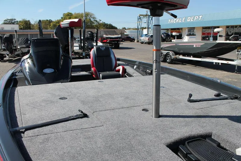 Slide: The Image of 2025 Phoenix 721 ZXL boat with spacious deck, parked near tackle shop. - 9