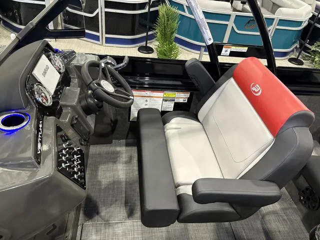 Slide: The Image of 2025 Princecraft Ventura 230 boat cockpit with steering wheel and captain's chair. - 13